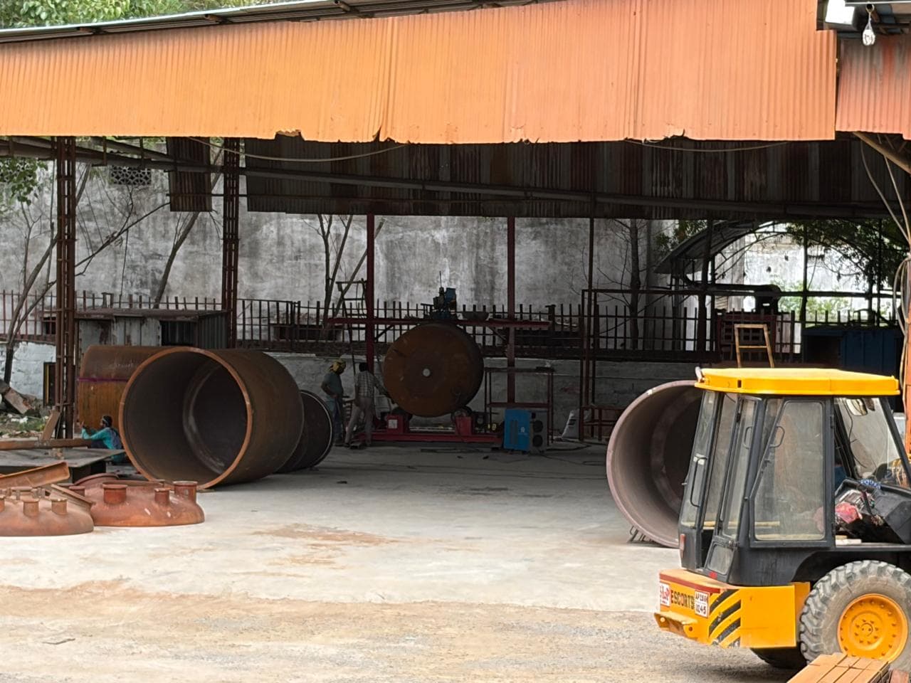 Factory yard with heavy equipment and steel structures — Jeedimetla, Hyderabad